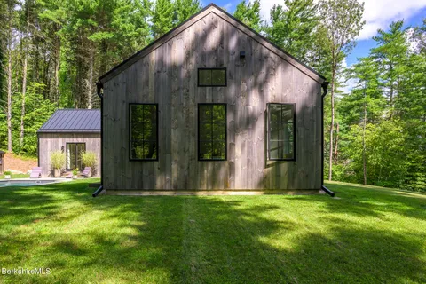 a swimming pool with outdoor seating and yard