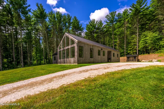 a view of a house with backyard and a tree