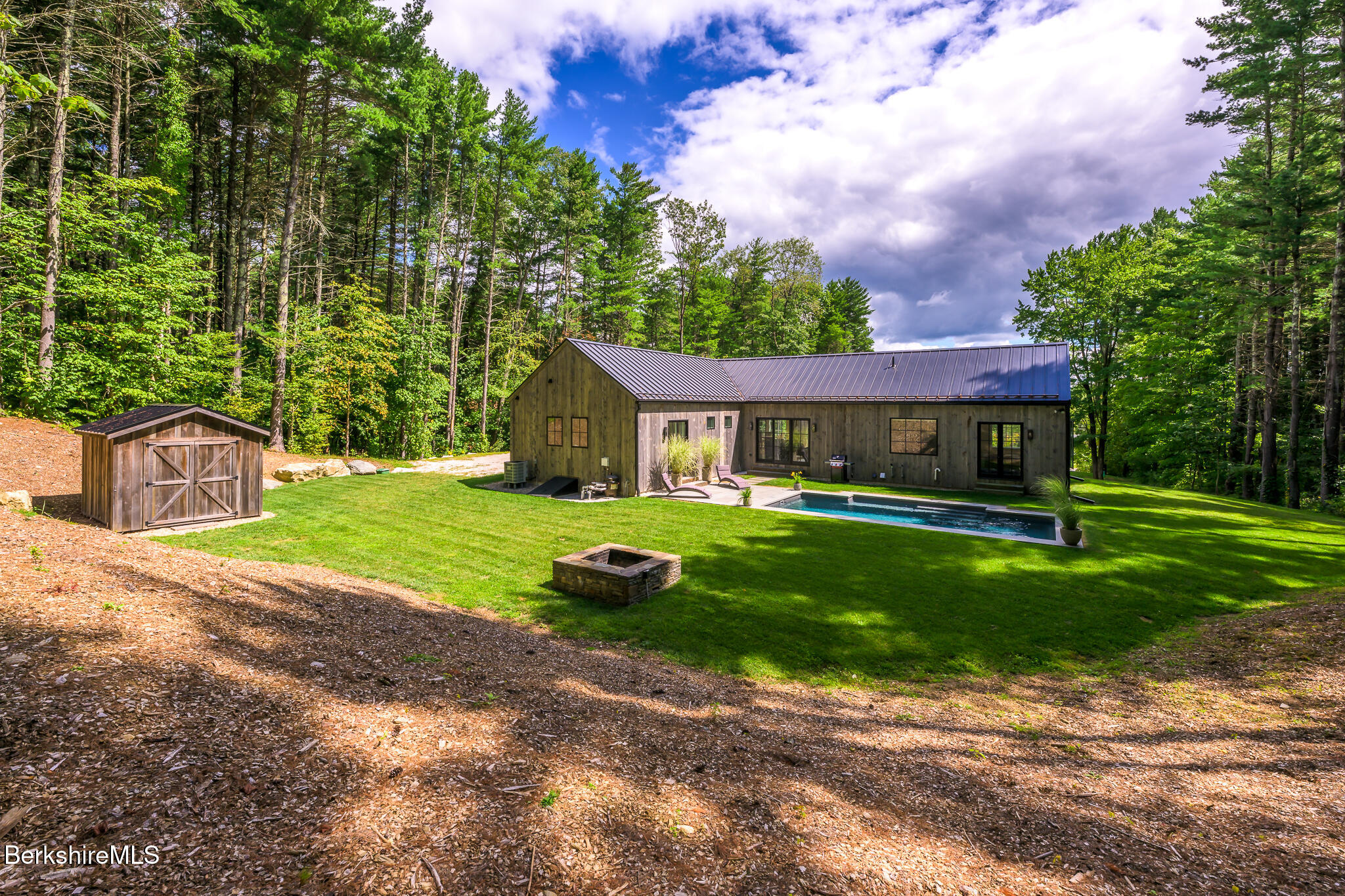 414 South Undermountain Road Sheffield, MA 01257 - Photo 6 of 37 a front view of a house with a yard and green space
