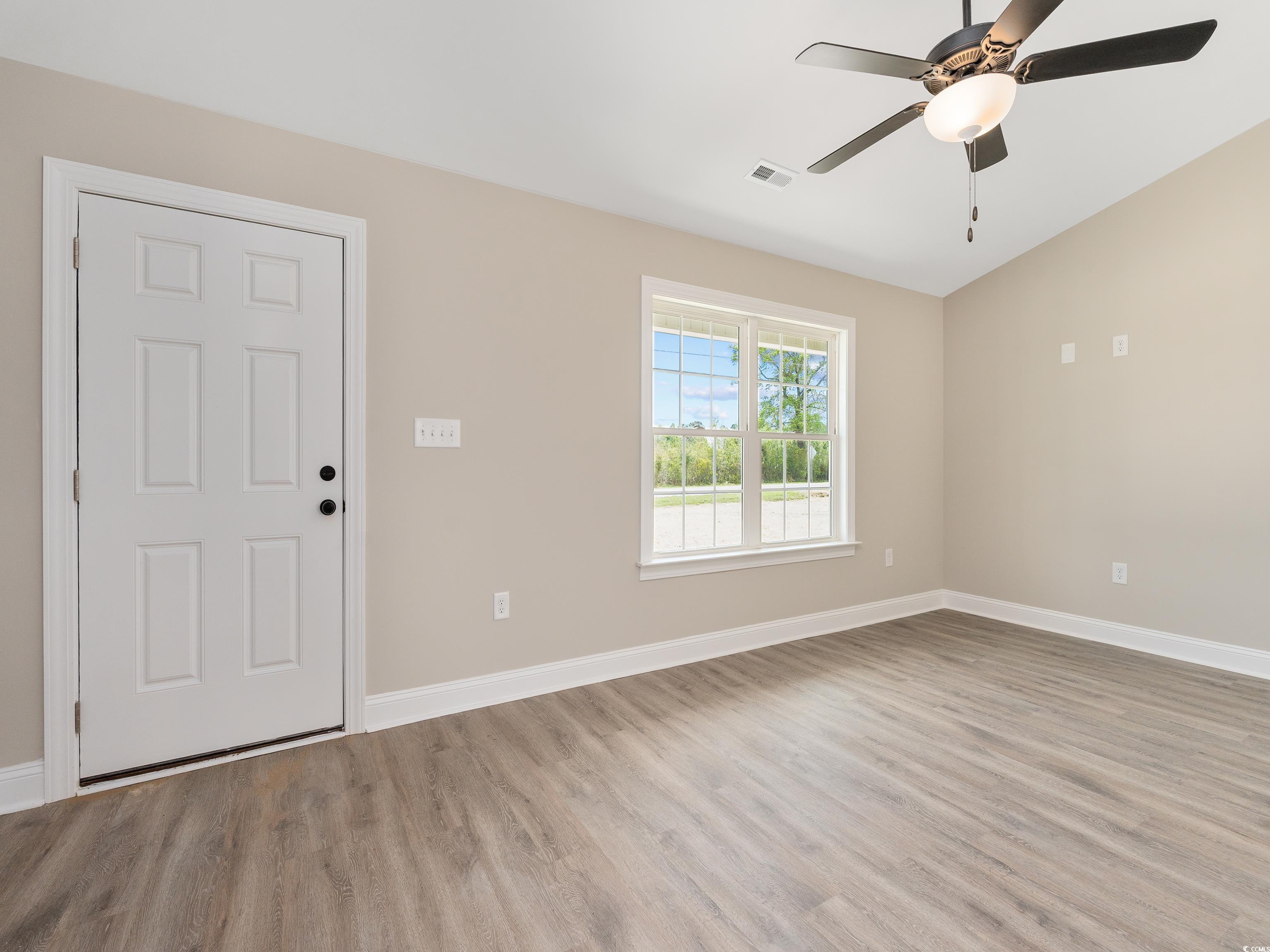 3409 B And S Road Loris, SC 29569 - Photo 3 of 24 Foyer with light wood finished floors, ceiling fan, and vaulted ceiling