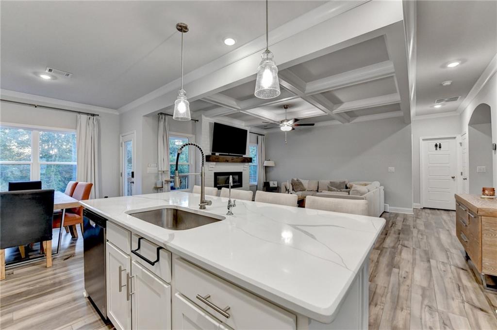 298 Ryston Way Grayson, GA 30017 - Photo 12 of 51 a large white kitchen with a large island attached withe living room