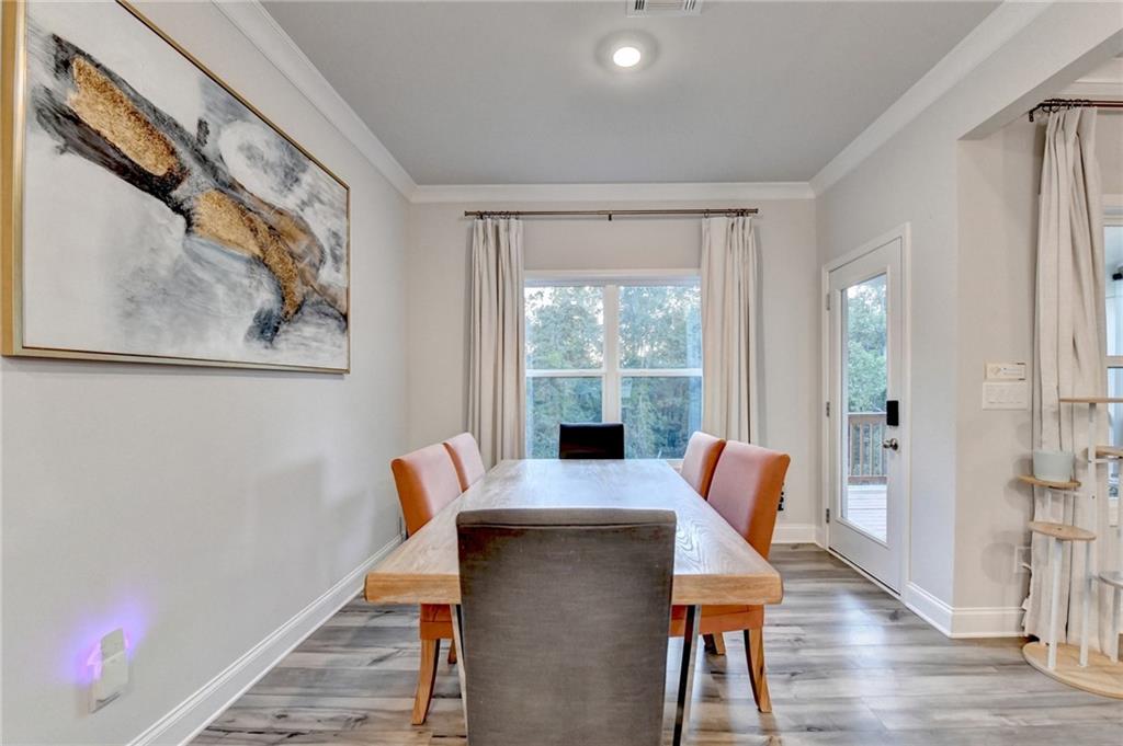 298 Ryston Way Grayson, GA 30017 - Photo 13 of 51 a view of a dining room with furniture window and wooden floor