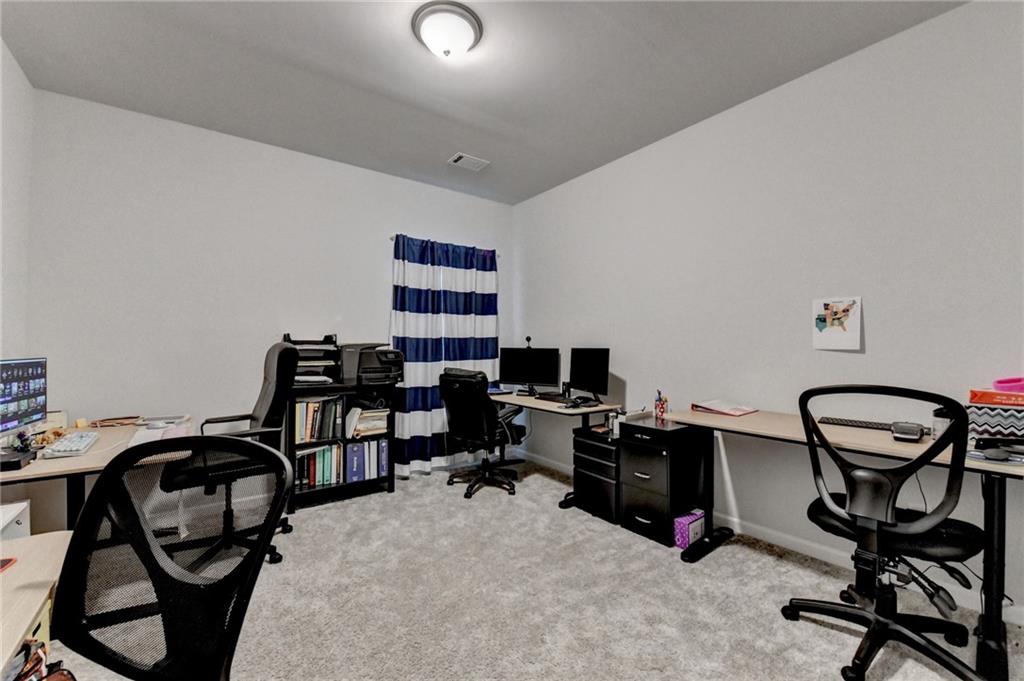 298 Ryston Way Grayson, GA 30017 - Photo 18 of 51 a view of a workspace with furniture and a gate