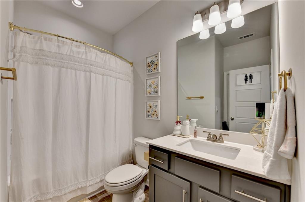 298 Ryston Way Grayson, GA 30017 - Photo 20 of 51 a bathroom with a sink a toilet and a mirror