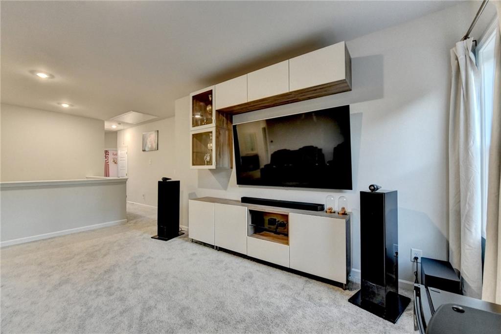 298 Ryston Way Grayson, GA 30017 - Photo 22 of 51 a living room with stainless steel appliances wooden floor and a fireplace
