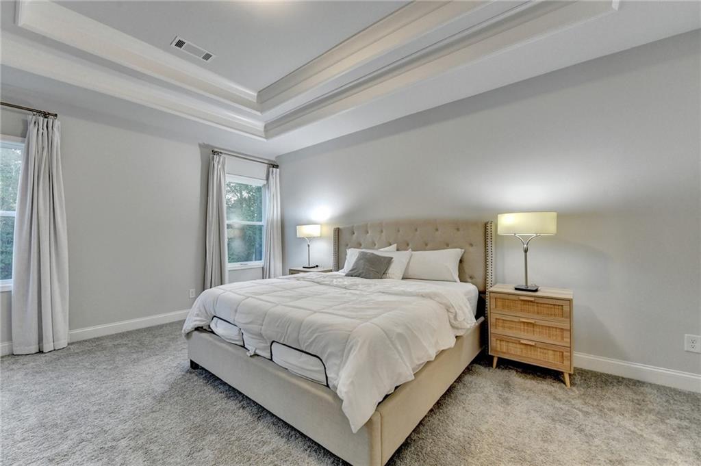 298 Ryston Way Grayson, GA 30017 - Photo 25 of 51 a bedroom with a bed and a night stand