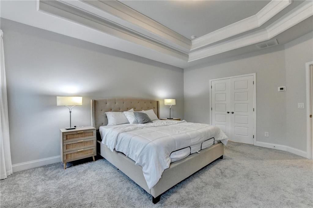 298 Ryston Way Grayson, GA 30017 - Photo 27 of 51 a bedroom with a bed and a night stand