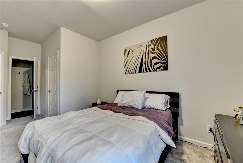 298 Ryston Way Grayson, GA 30017 - Photo 32 of 51 a bedroom with a bed and painting on the wall