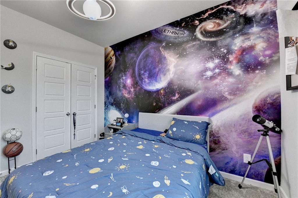 298 Ryston Way Grayson, GA 30017 - Photo 34 of 51 a bedroom with a bed and a chandelier