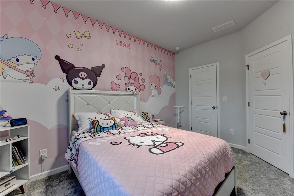 298 Ryston Way Grayson, GA 30017 - Photo 37 of 51 a bedroom with a bed and a book shelf