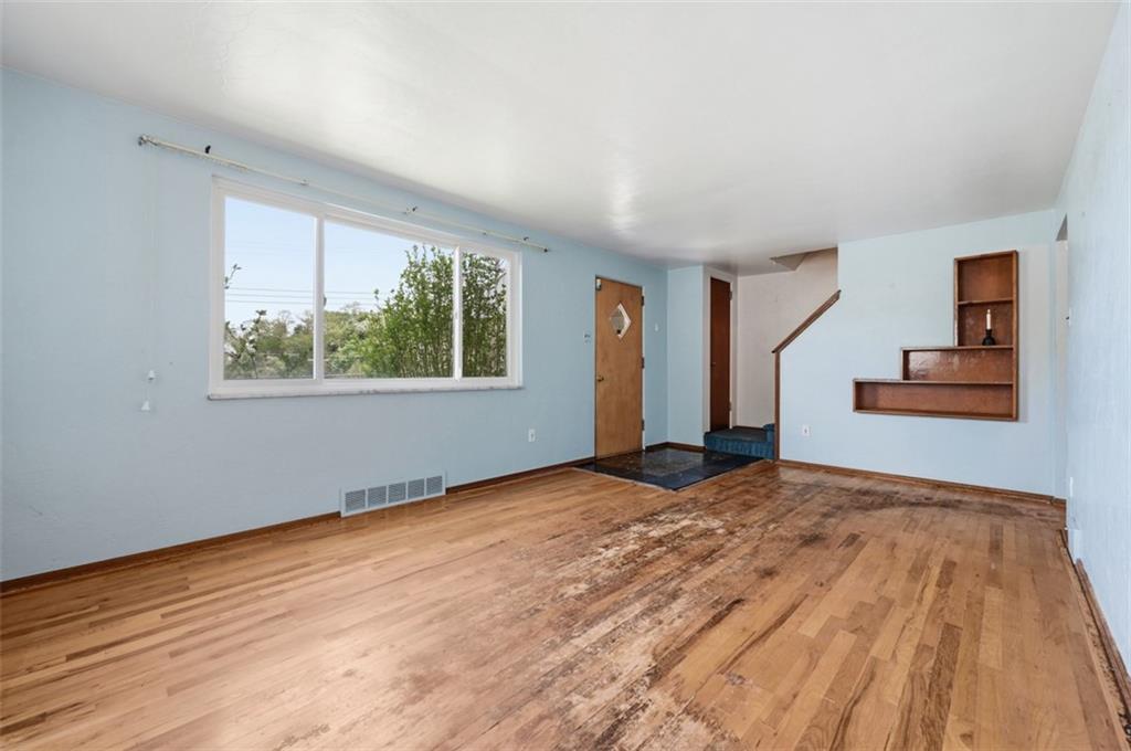 328 Ruthwood Avenue Pittsburgh, PA 15227 - Photo 5 of 32 a view of an empty room with wooden floor and a window