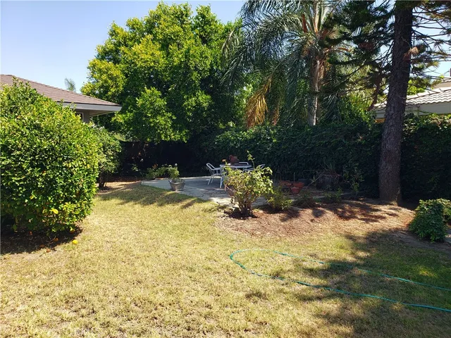 a backyard of a house with yard and outdoor seating