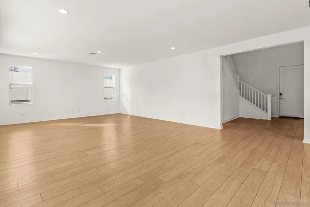 a view of a room with wooden floor and white walls