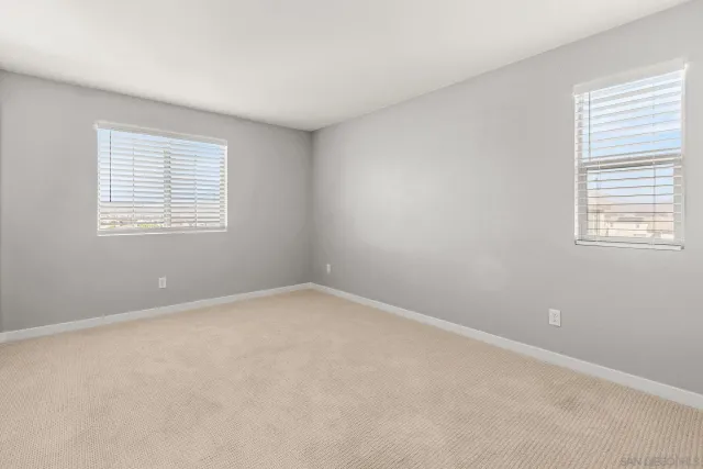 a bathroom with a granite countertop sink toilet a large mirror a bathtub and shower