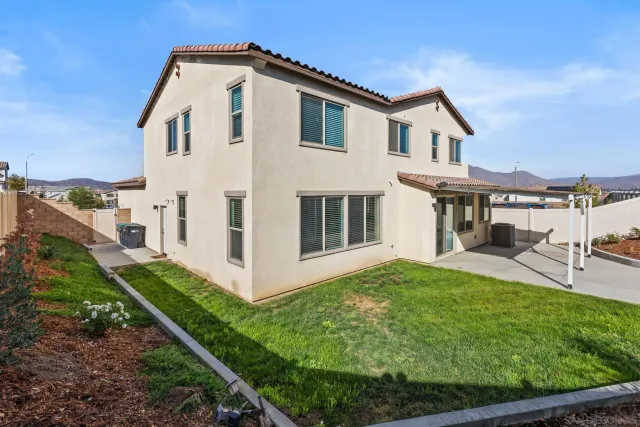 a view of a house with a yard and a garden