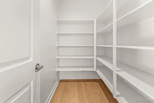 a view of a room with shelves on the wall