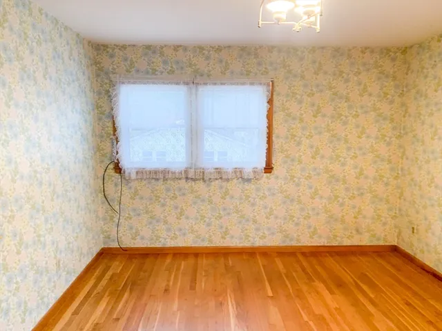 a view of a room with wooden floor and brick wall