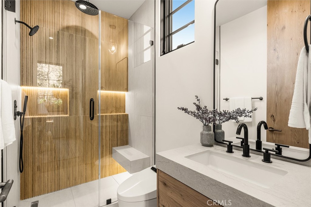 12249 Addison Street Valley Village, CA 91607 - Photo 12 of 60 a bathroom with a double vanity sink toilet and shower
