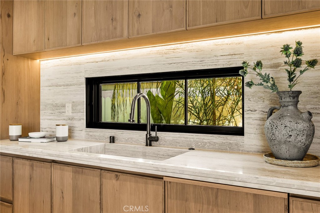 12249 Addison Street Valley Village, CA 91607 - Photo 26 of 60 a bathroom with a sink and a large mirror