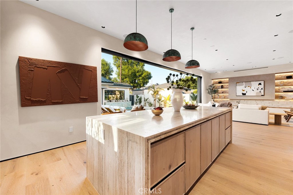 12249 Addison Street Valley Village, CA 91607 - Photo 27 of 60 a kitchen with stainless steel appliances kitchen island a large counter space and a view of living room