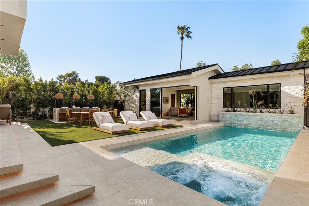 12249 Addison Street Valley Village, CA 91607 - Photo 32 of 60 a view of a house with swimming pool and sitting area