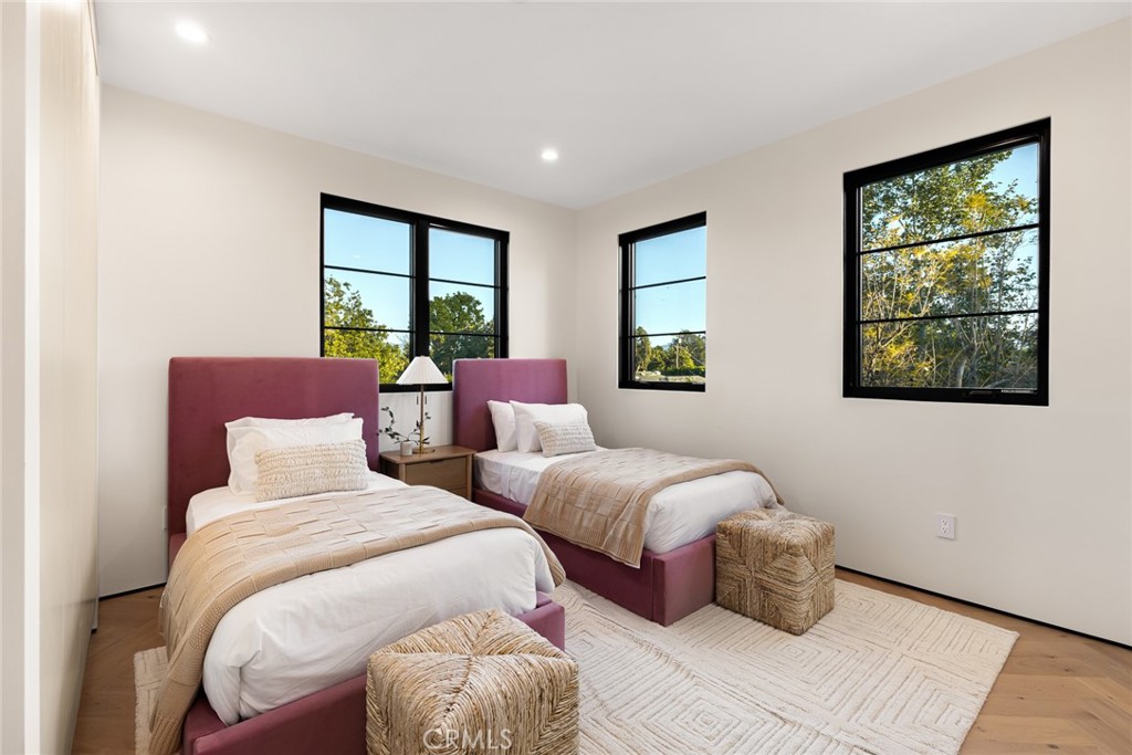 12249 Addison Street Valley Village, CA 91607 - Photo 41 of 60 a bedroom with two beds and a large window