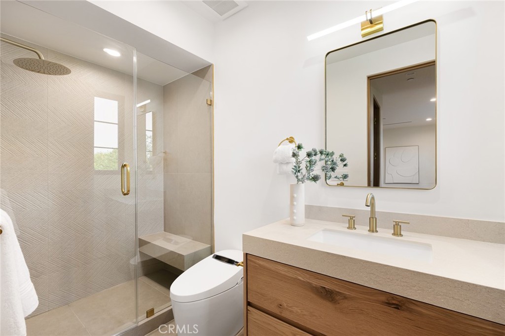 12249 Addison Street Valley Village, CA 91607 - Photo 42 of 60 a bathroom with a sink vanity granite toilet and a mirror
