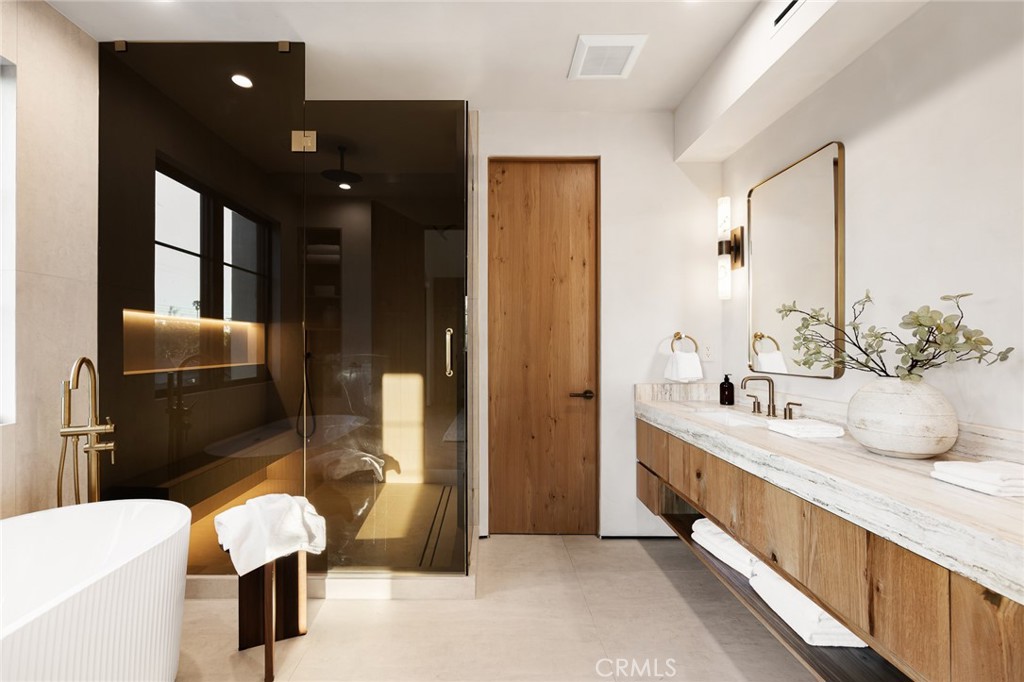 12249 Addison Street Valley Village, CA 91607 - Photo 53 of 60 a bathroom with double vanity and a bathtub