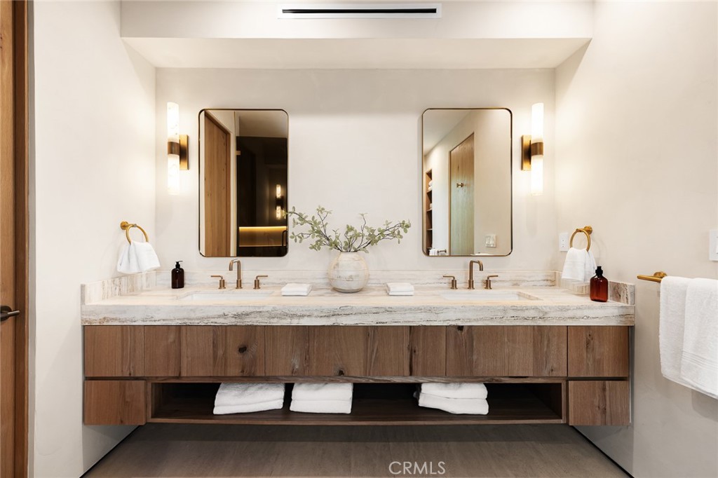 12249 Addison Street Valley Village, CA 91607 - Photo 54 of 60 a bathroom with a double vanity sink and a mirror