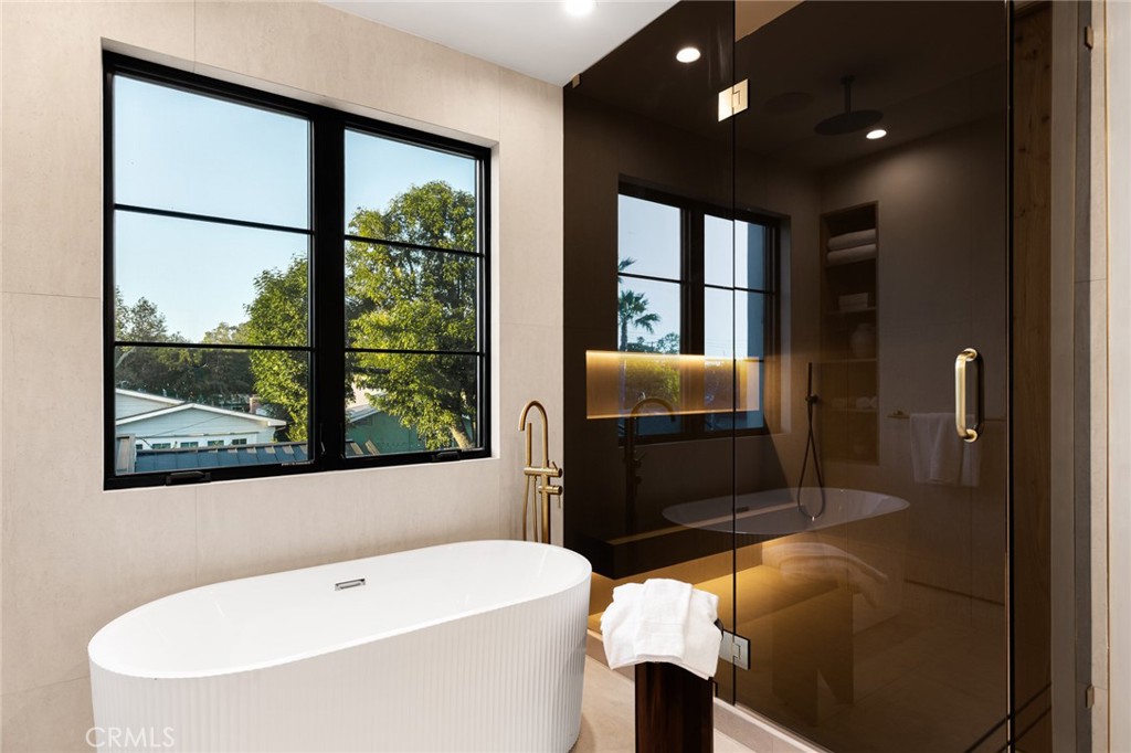 12249 Addison Street Valley Village, CA 91607 - Photo 55 of 60 a bathroom with a sink a bathtub and next to a window