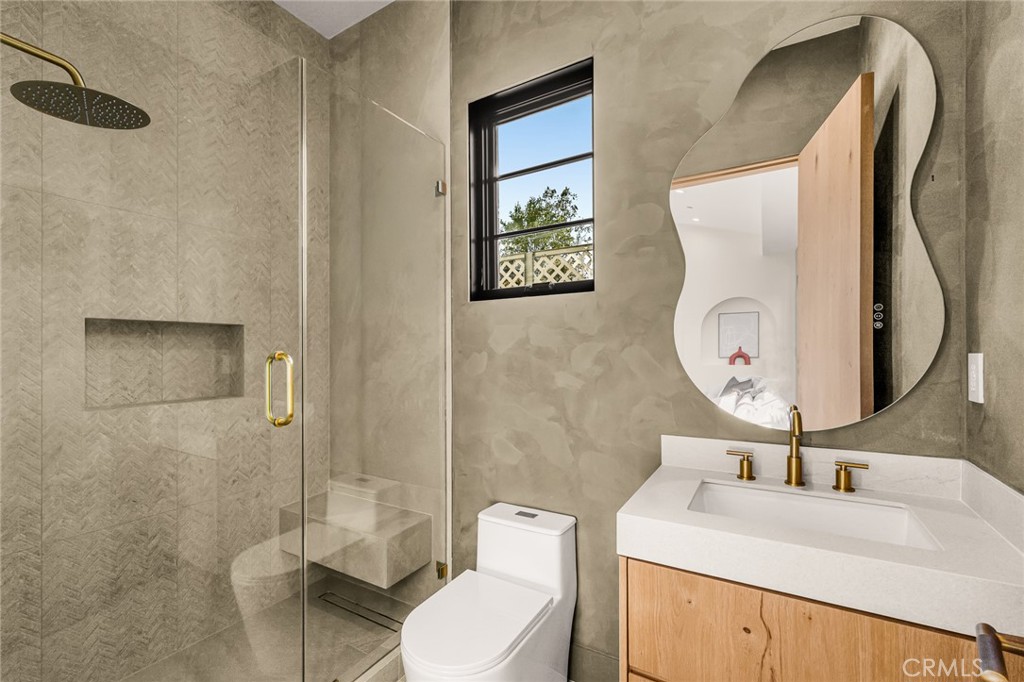 12249 Addison Street Valley Village, CA 91607 - Photo 59 of 60 a bathroom with a toilet sink and mirror
