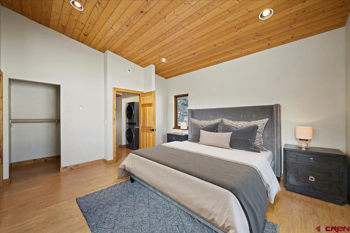 1578 Aspen Drive Ridgway, CO 81432 - Photo 23 of 45 a bedroom with a bed and wooden floor