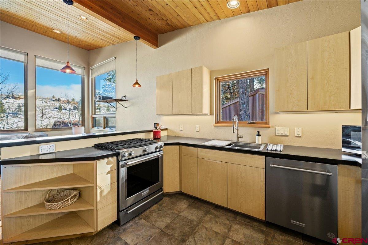1578 Aspen Drive Ridgway, CO 81432 - Photo 25 of 45 a kitchen with a sink stove and cabinets