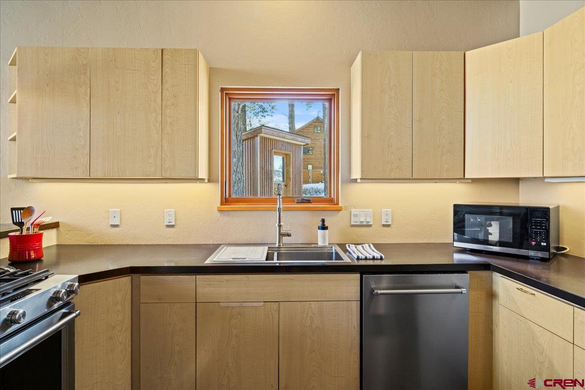 1578 Aspen Drive Ridgway, CO 81432 - Photo 27 of 45 a kitchen with granite countertop cabinets sink and a stove