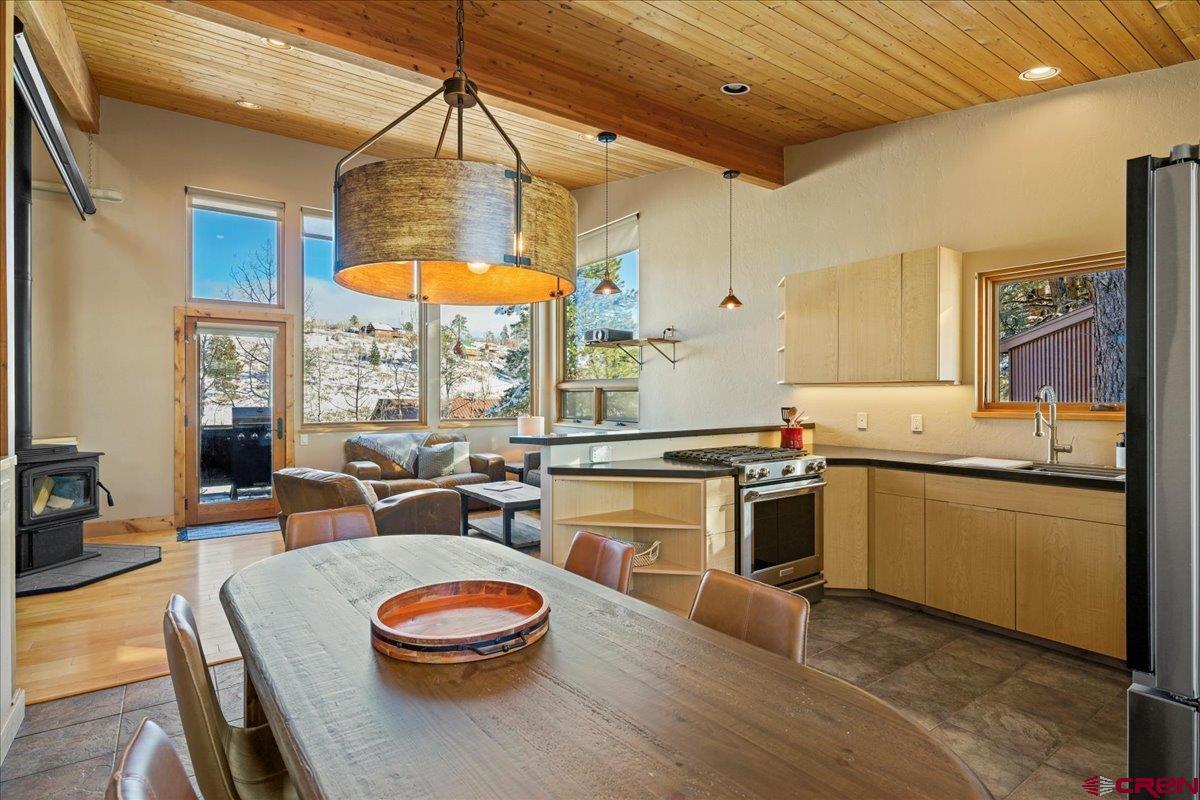 1578 Aspen Drive Ridgway, CO 81432 - Photo 35 of 45 a kitchen with a table chairs stove and wooden floor