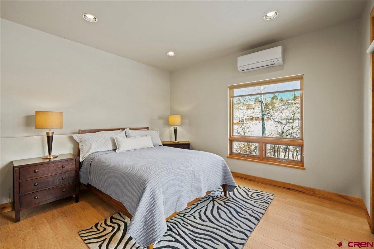 1578 Aspen Drive Ridgway, CO 81432 - Photo 40 of 45 a bedroom with a bed and a lamp on dresser