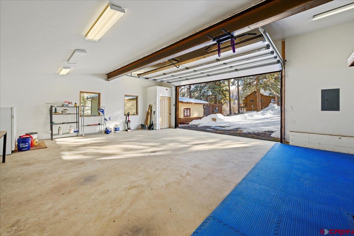 1578 Aspen Drive Ridgway, CO 81432 - Photo 9 of 45 a view of a bedroom with wooden floor and windows