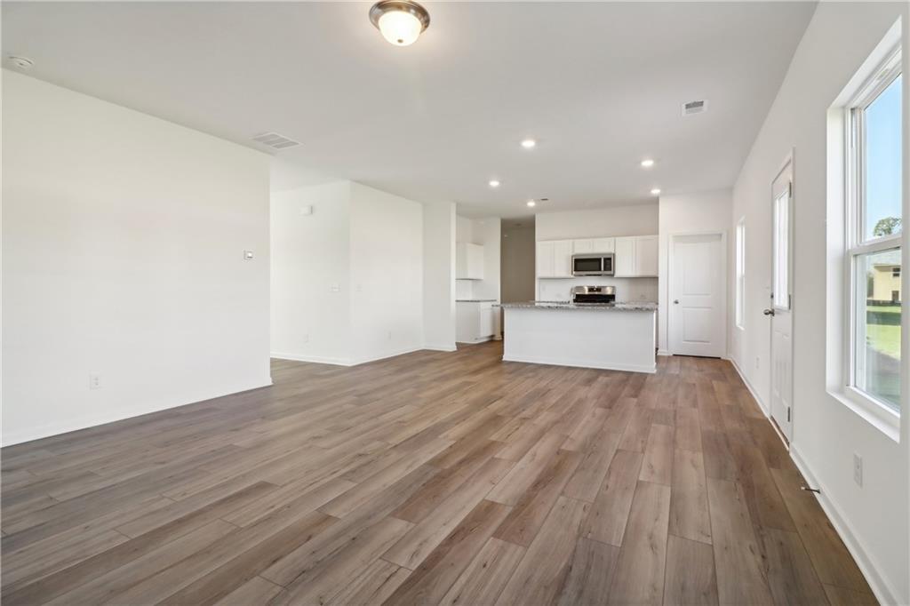 2115 Boxwood Circle Conyers, GA 30013 - Photo 11 of 42 a view of a kitchen with a stove and wooden floor