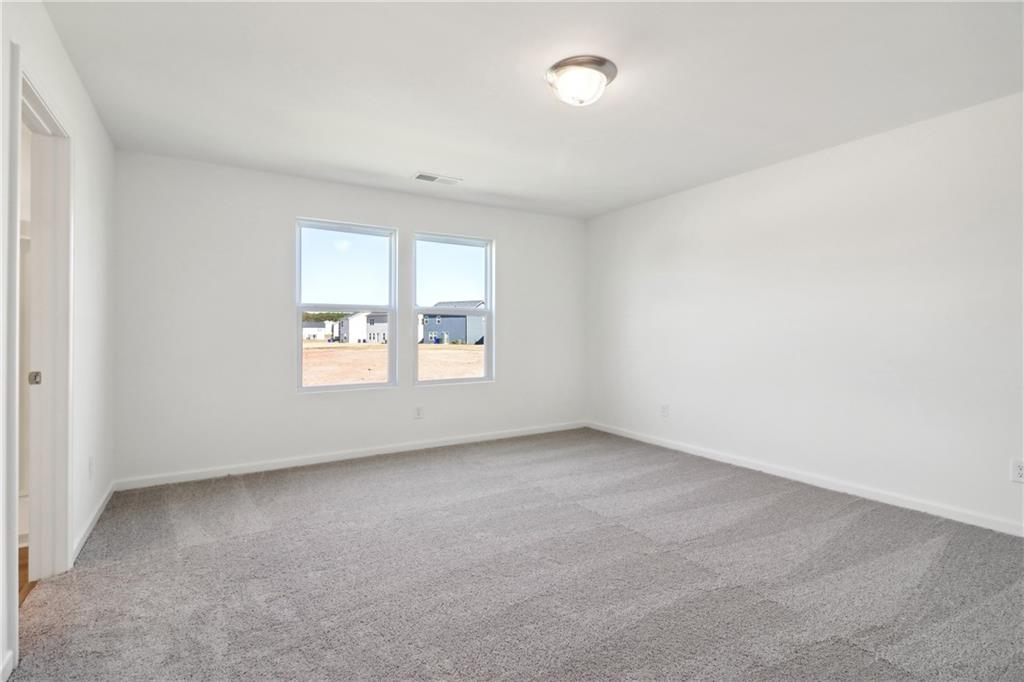 2115 Boxwood Circle Conyers, GA 30013 - Photo 16 of 42 an empty room with windows