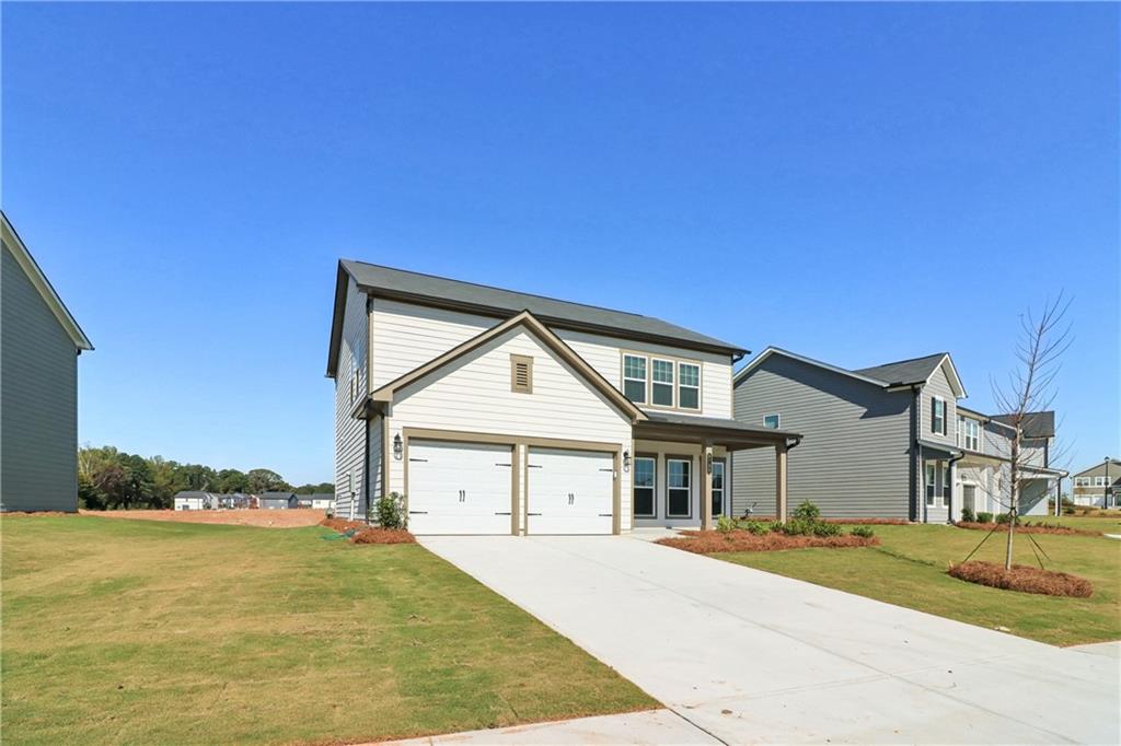 2115 Boxwood Circle Conyers, GA 30013 - Photo 2 of 42 a front view of a house with a yard and garage