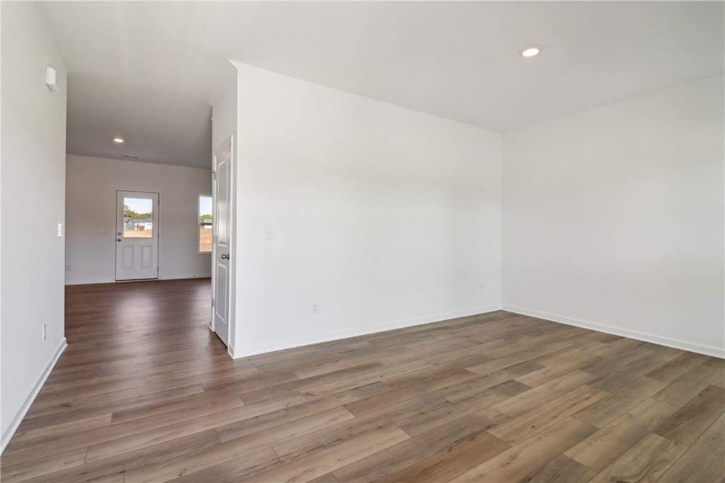 2115 Boxwood Circle Conyers, GA 30013 - Photo 4 of 42 wooden floor in an empty room with a window