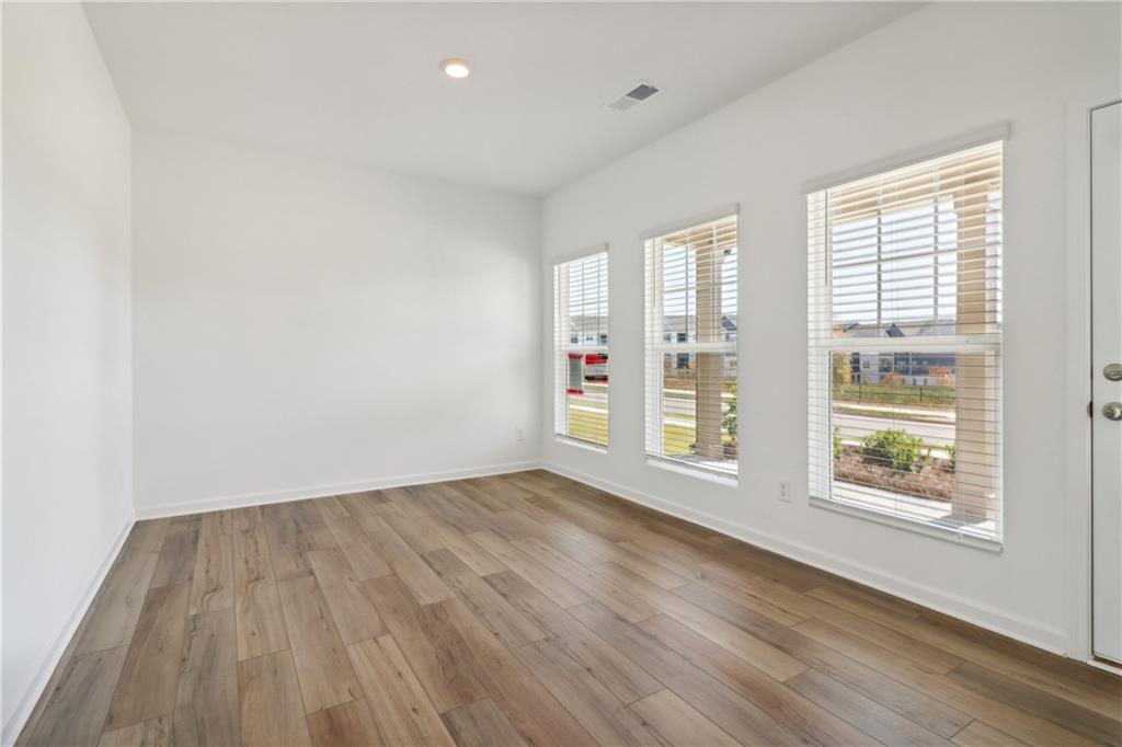 2115 Boxwood Circle Conyers, GA 30013 - Photo 5 of 42 an empty room with wooden floor and windows