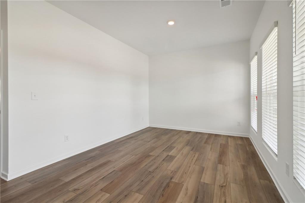 2115 Boxwood Circle Conyers, GA 30013 - Photo 6 of 42 a view of an empty room with wooden floor and a window