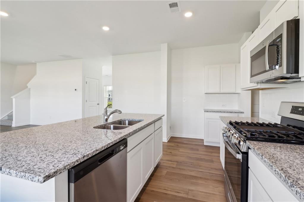 2115 Boxwood Circle Conyers, GA 30013 - Photo 8 of 42 a kitchen with stainless steel appliances granite countertop a sink stove and cabinets