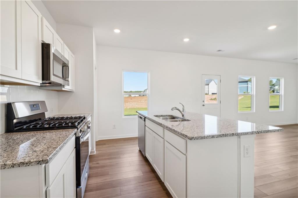 2115 Boxwood Circle Conyers, GA 30013 - Photo 9 of 42 a kitchen with stainless steel appliances granite countertop a sink stove and cabinets