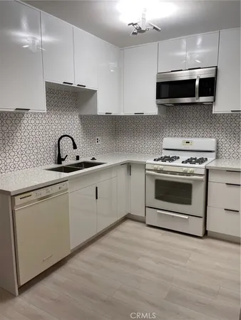 a kitchen with a sink stove and cabinets