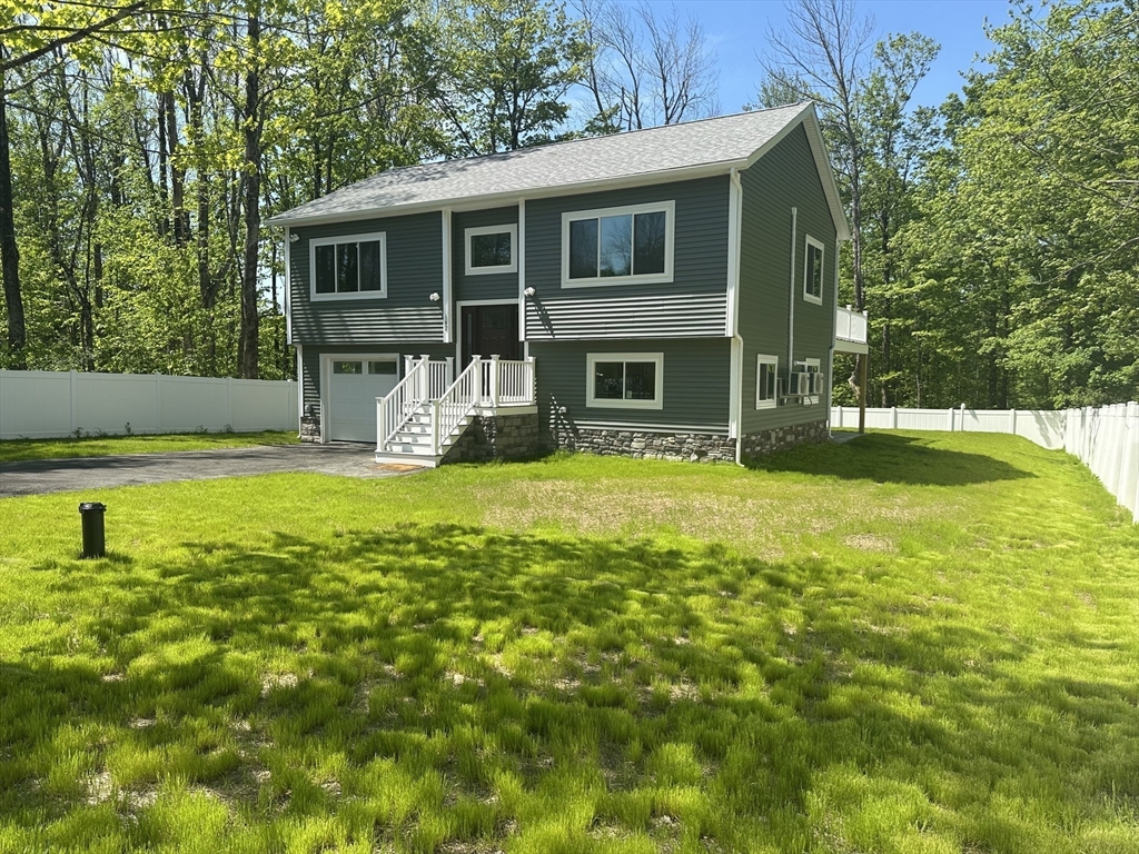 102 Wells Road Becket, MA 01223 - Photo 2 of 40 a view of a house with a yard patio and a tree