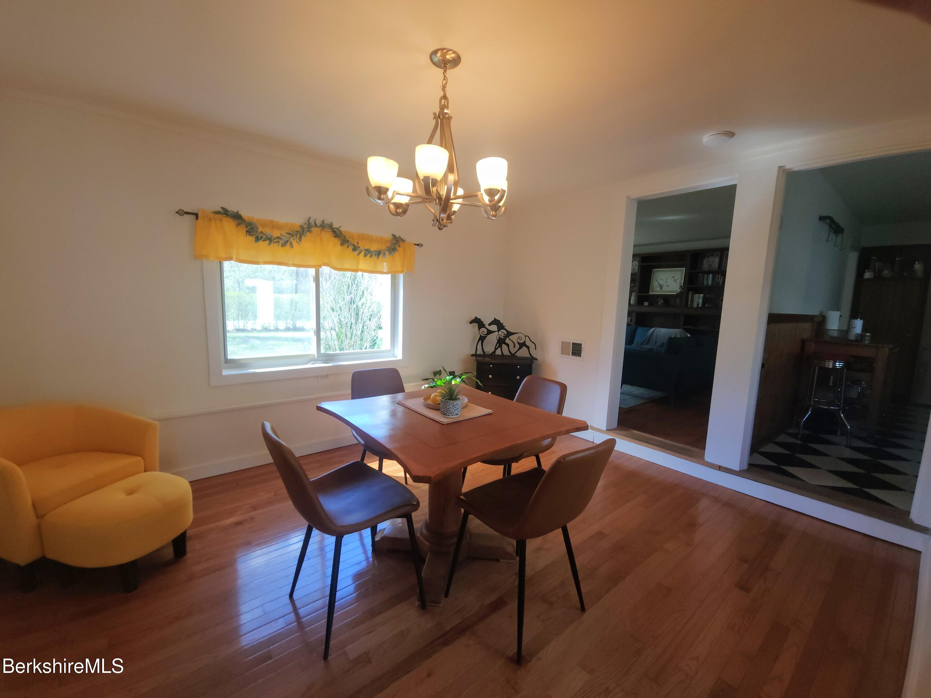 16 East New Lenox Road Lenox, MA 01240 - Photo 11 of 31 a view of a dining room with furniture a chandelier and wooden floor