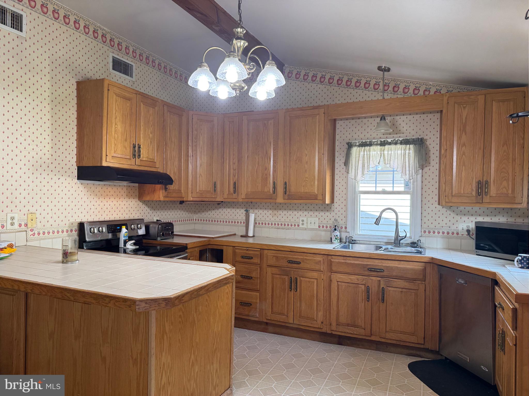 304 Cool Hollow Road Falling Waters, WV 25419 - Photo 20 of 42 a kitchen with a sink a window and cabinets