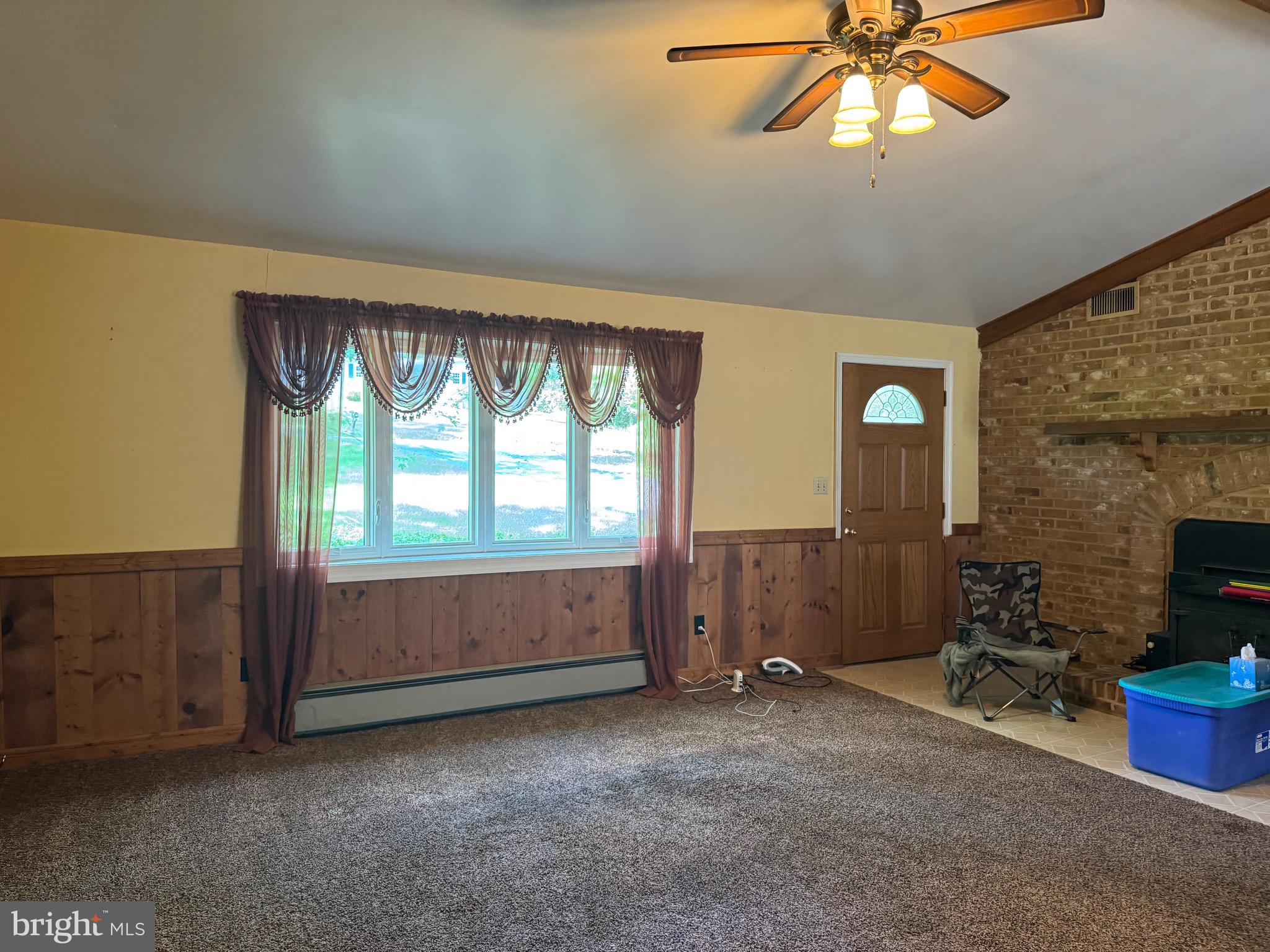 304 Cool Hollow Road Falling Waters, WV 25419 - Photo 26 of 42 an empty room with a fireplace and windows